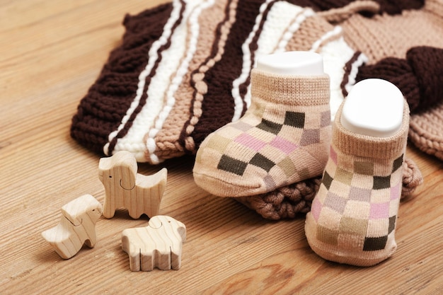 Neue Babysocken auf Holzbrett Neugeborenen- und Babykonzept