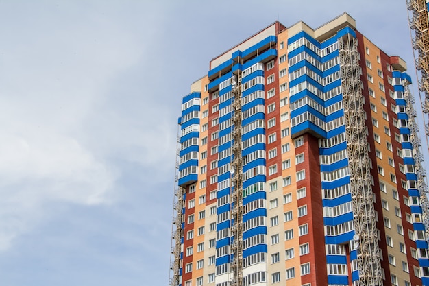 Neuer Block der modernen Wohnungen mit Balkonen und blauem Himmel