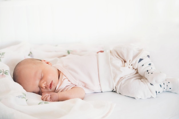 Neugeborenes Baby schläft die ersten Tage des Lebens. Nettes kleines Neugeborenes, das friedlich schläft