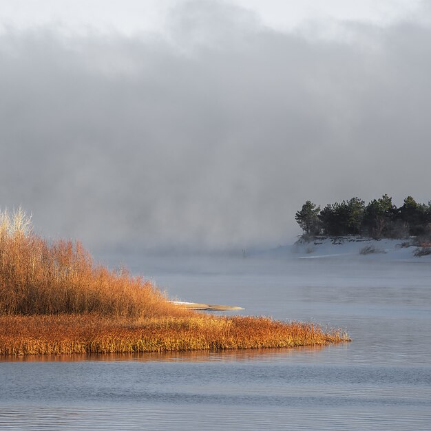 Névoa gelada de inverno em um rio descongelado