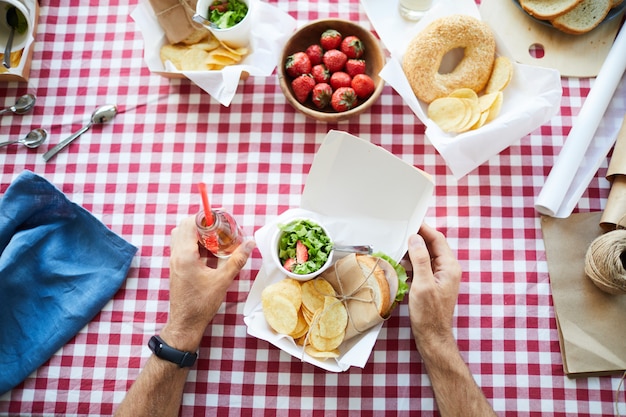 Nicht erkennbarer Mann am Picknicktisch