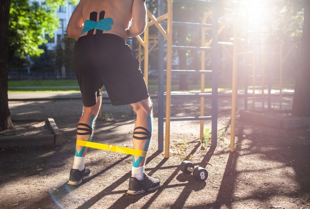 Nicht erkennbares männliches Sportlertraining mit Widerstandsband im Freien.