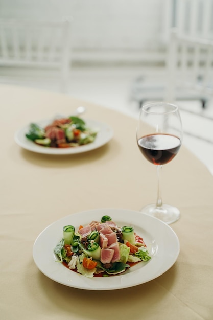 Nicoise-Salat mit einem Glas Rotwein