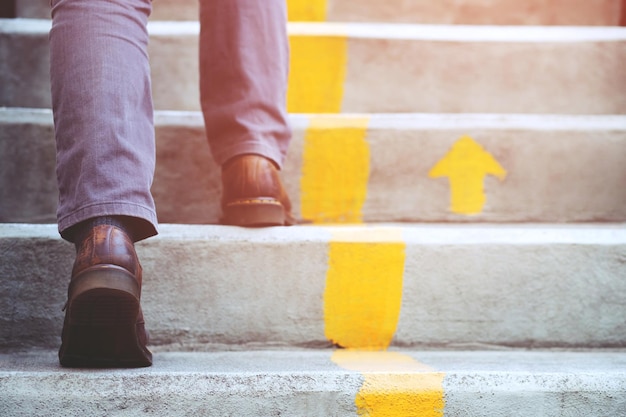 Niedriger Teil eines Mannes, der auf einer Treppe steht