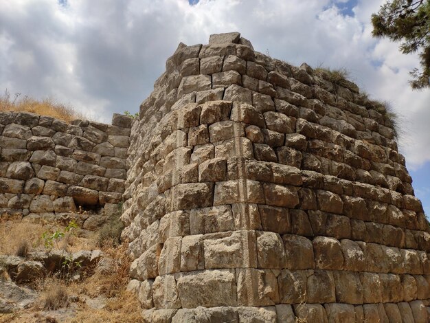 Foto niedrigwinkelansicht der steinmauer vor bewölktem himmel