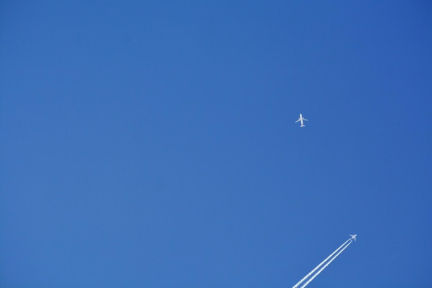 Foto niedrigwinkelansicht eines flugzeugs, das gegen einen klaren blauen himmel fliegt