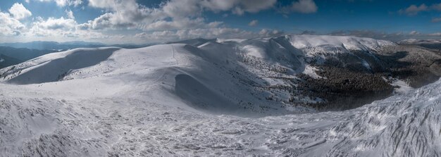 La nieve y el viento formaron formaciones de hielo cubiertas de mesetas montañosas de invierno con cornisas de nieve en un magnífico día soleado en la pintoresca y hermosa cresta alpina