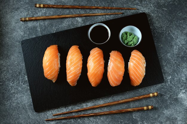 Nigiri-Sushi mit wildem Lachs auf schwarzem Servierbrett