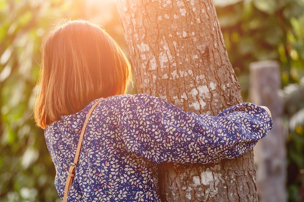 Niña abrazando el arbol