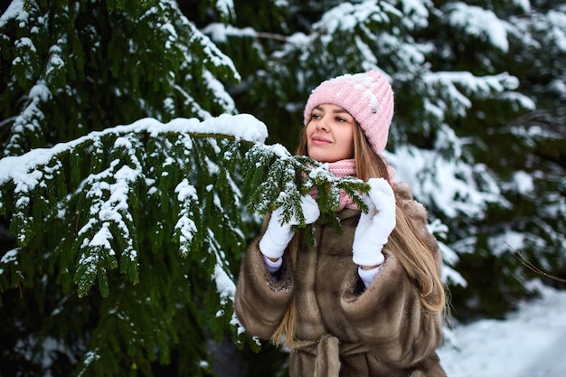 Foto niña con abrigo de piel en un parque de invierno