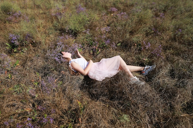 Foto niña acostada en un prado en la hierba