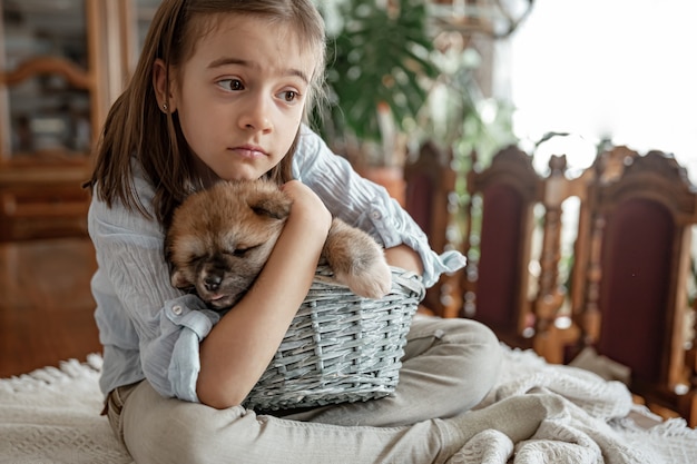 Una niña ama y abraza a su perrito.