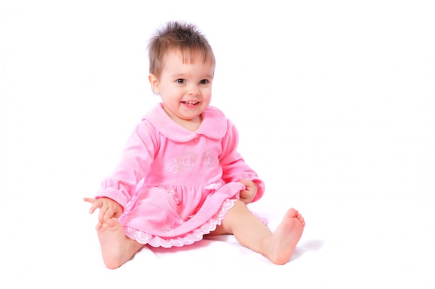Foto niña de un año con un vestido rosa
