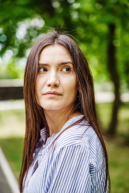 Una niña de apariencia asiática en un parque de la ciudad Retrato de verano del joven tártaro