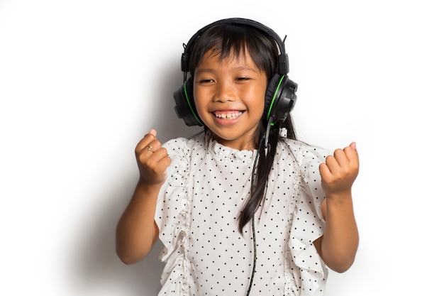 Niña asiática disfrutando de la música. bailar y moverse expresando verdaderas emociones positivas