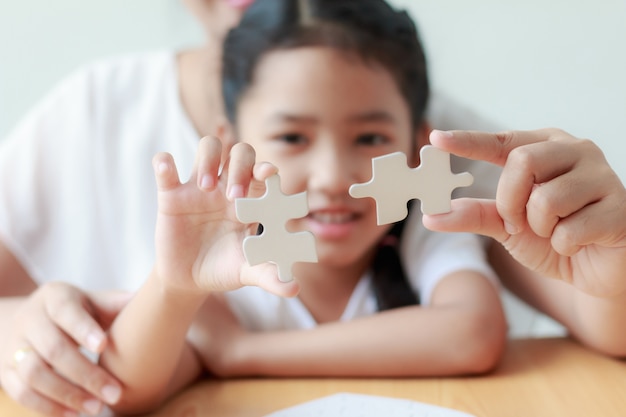 Niña asiática jugando rompecabezas