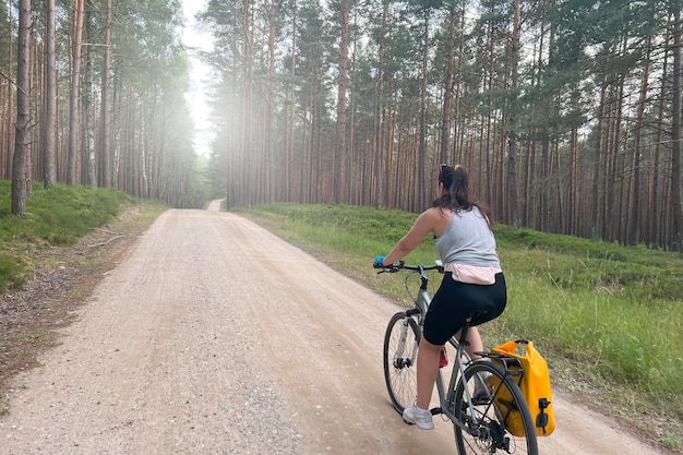 Niña de la aventura del bosque en bicicleta a través de la belleza de la naturaleza Concepto de recreación en la naturaleza