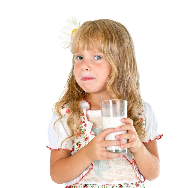 Niña con bigote de leche después de beber leche. Aislado sobre fondo blanco