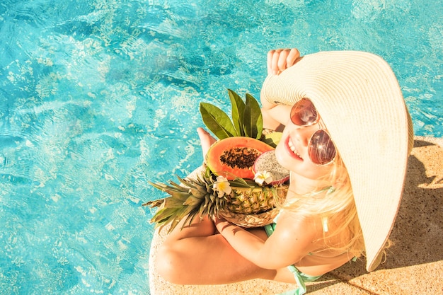 Niña bonita en piscina, vacaciones de verano.