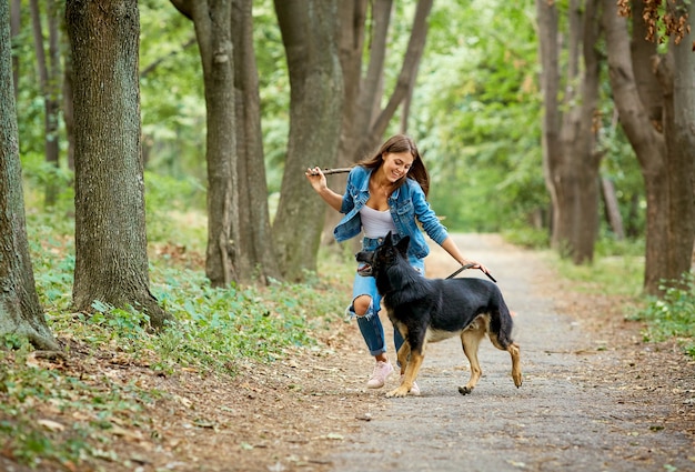 Una niña camina con un perro pastor alemán