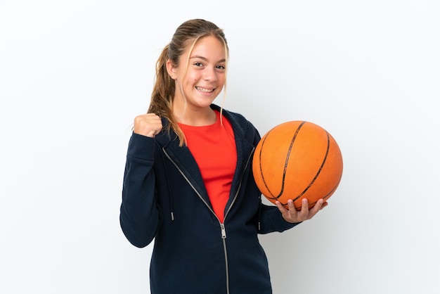 Niña caucásica aislada sobre fondo blanco jugando baloncesto