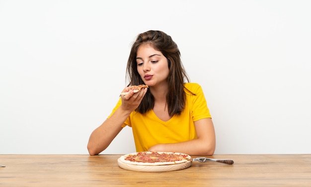 Foto niña caucásica con una pizza