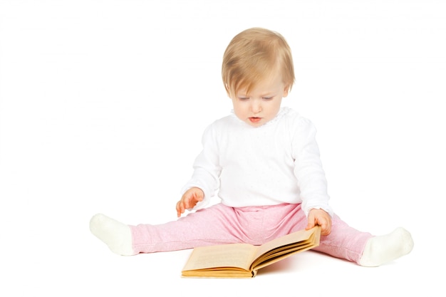 Niña caucásica sosteniendo un libro aislado en blanco