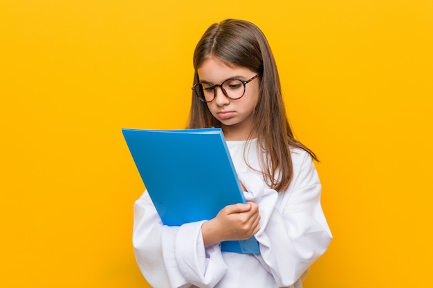 Niña caucásica vistiendo un traje de médico