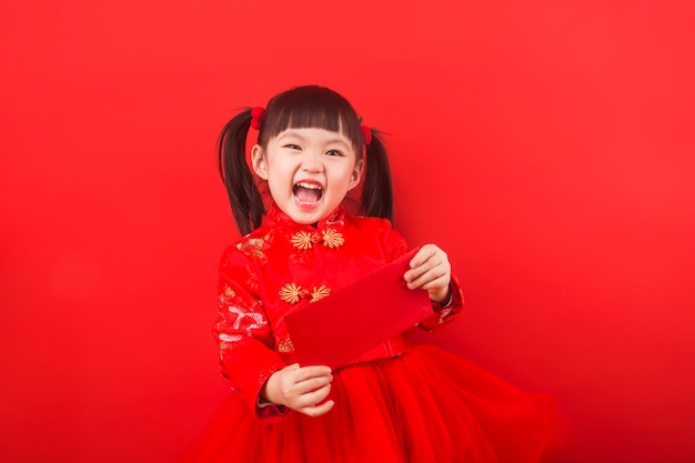 Una niña china celebra el año nuevo chino con un sobre rojo