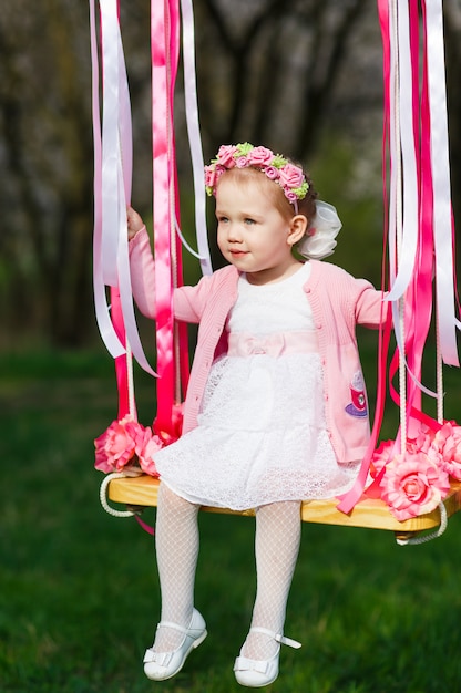 Foto niña en el columpio, niña en el parque