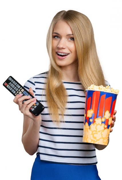 Niña comiendo palomitas de maíz y viendo televisión