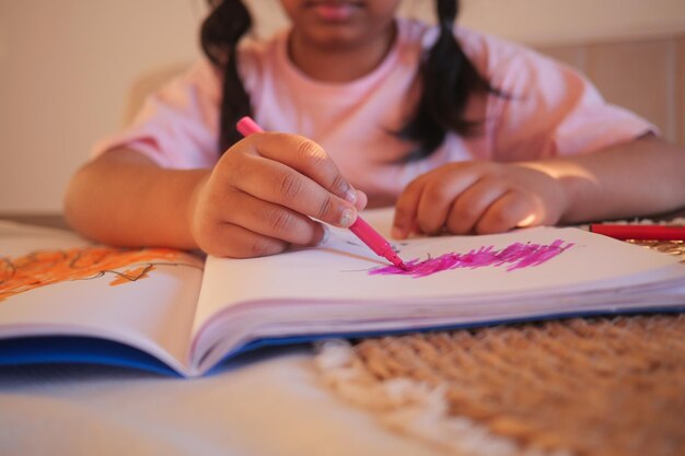 Foto niña dibujando en papel sentada en el suelo