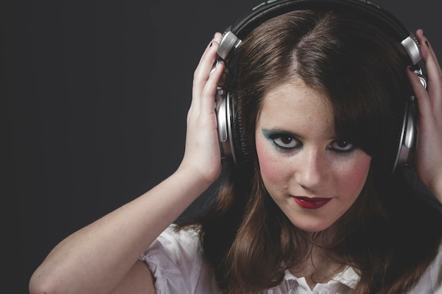 niña escuchando música con enormes auriculares