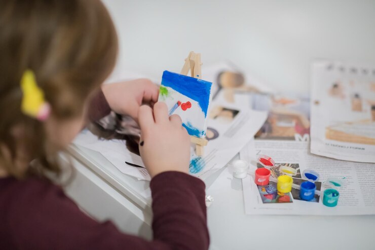 Foto niña feliz pintando sobre lienzo imagen en casa