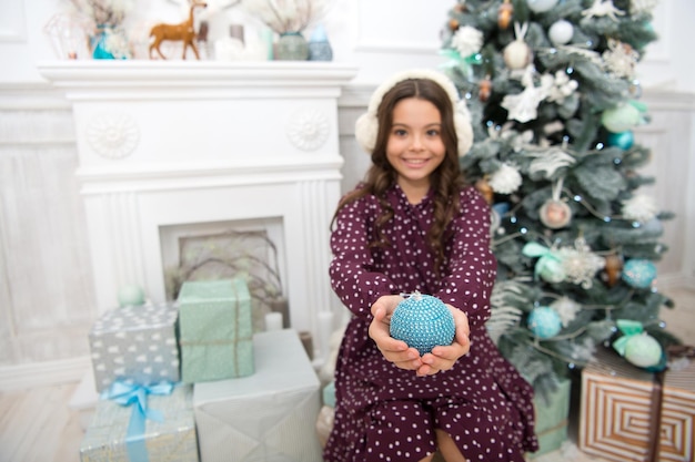 A la niña le gusta el presente de Navidad. Navidad. Niño disfruta de las vacaciones. Feliz Año Nuevo. pequeña niña feliz en navidad. La mañana antes de Navidad. Vacaciones de año nuevo. Deseo.