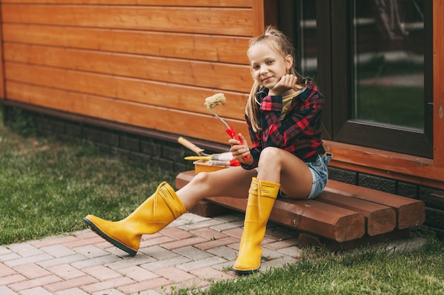 Niña hermosa pintando la casa