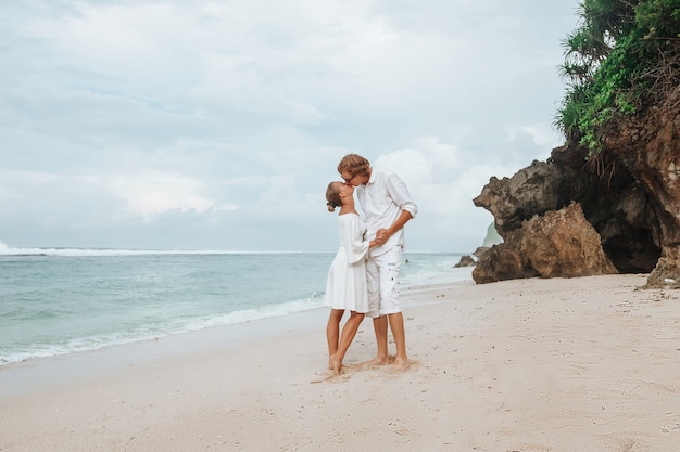 Niña y hombre, en, ropa blanca, besar, en, playa blanca