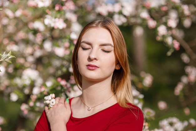 Niña en un huerto de manzanos en flor