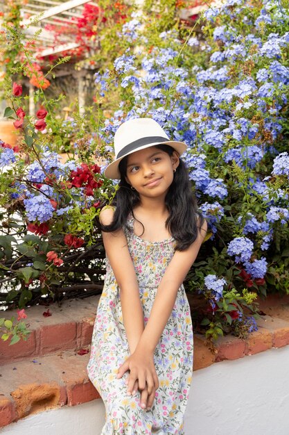 Niña latina con sombrero de paja y vestido