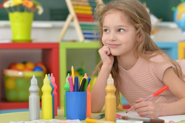 Niña linda estudiante en la clase de arte en la escuela