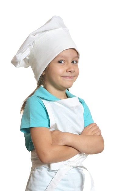 Niña linda posando en uniforme de chef con los brazos cruzados