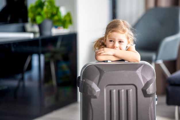 Niña con maleta equipaje equipaje lista para viajar de vacaciones