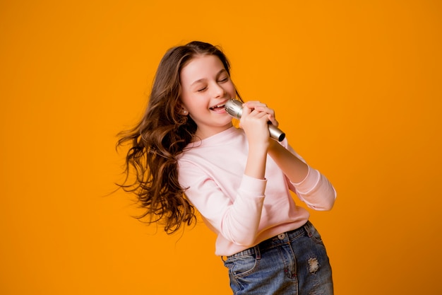 niña con micrófono sonriendo cantando