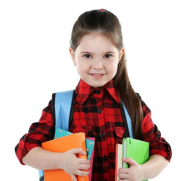 Niña con mochila azul sosteniendo libros aislados en blanco