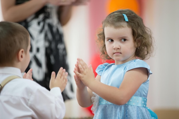 Niña y niño bailando en la matiné