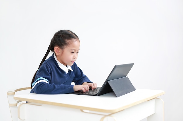 Niña niño usando una computadora portátil en la escuela