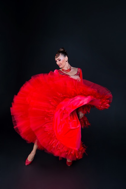 Foto niña o mujer en vestido rojo sobre fondo negro, bailarina pereatty.