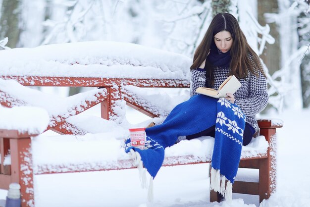 niña en un parque de nieve de invierno bufanda