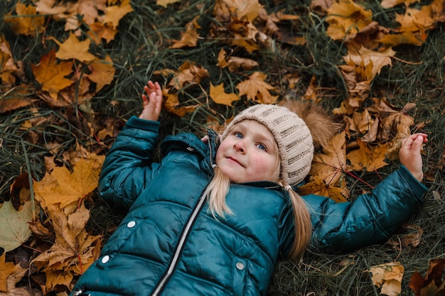 Niña en el parque de otoño