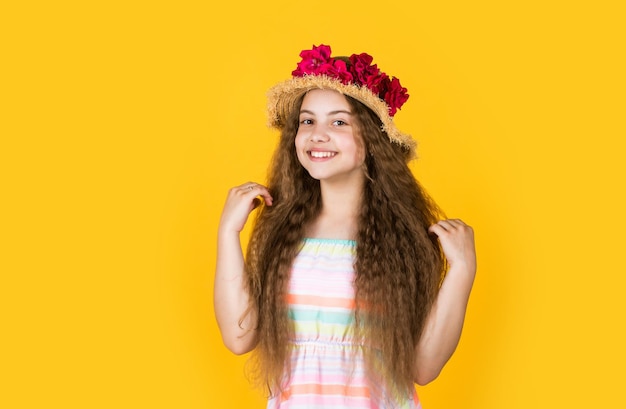 Niña pequeña con rosa de verano en sombrero vacaciones de verano y vacaciones belleza femenina y moda infancia felicidad niño feliz con decoración floral en sombreros niño en sombrero de primavera